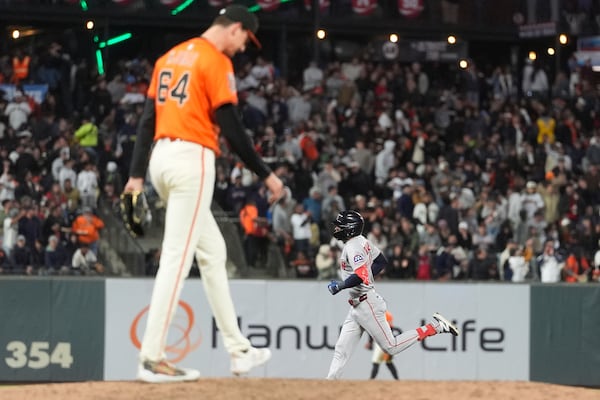 San Francisco Giants pitcher Sean Hjelle, foreground, reacts after a home run by Boston Red Sox's Ceddanne Rafaela, bottom, during the sixth inning of a baseball game in San Francisco, Friday, June 20, 2025. (AP Photo/Jeff Chiu)