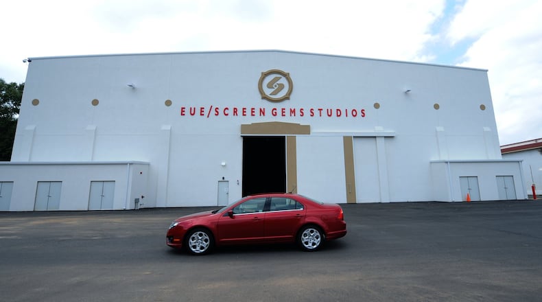 A car passes in front of one of the giant buildings at EUE/Screen Gems Studios. The studios has rehabbed historic buildings at the old Lakewood Fairground south of the city of Atlanta and built a 37,000 square foot sound stage - one of the largest in the country - to produce millions of dollars worth of films. Johnny Crawford jcrawford@ajc.com