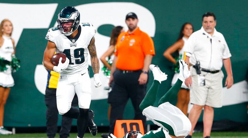 Philadelphia Eagles' J.J. Arcega-Whiteside (19) breaks a tackle by New York Jets' Elijah Campbell (26) to score a touchdown during the first half of an NFL preseason football game Friday, Aug. 27, 2021, in East Rutherford, N.J. (AP Photo/Noah K. Murray)