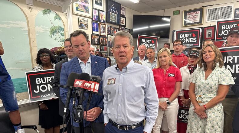 Gov. Brian Kemp (right) campaigns with Lt. Gov. Burt Jones shortly after endorsing him in the Republican primary for governor. (Greg Bluestein/AJC)