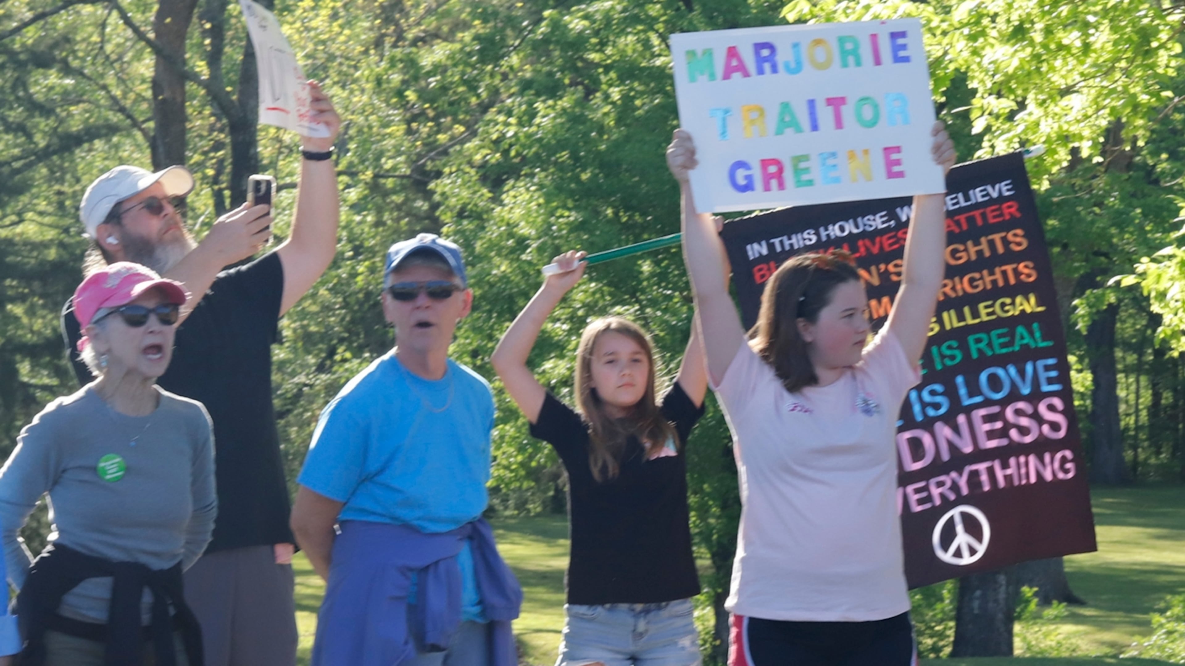 Protesters rallied in Acworth earlier this year outside of the town hall being held by Marjorie Taylor Greene, who announced last month that she is resigning from Congress. (Jenni Girtman for the AJC)