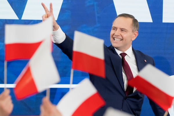Karol Nawrocki, presidential candidate for the 2025 Polish presidential election supported by Poland's national conservative Law and Justice party, waves to supporters as first exit polls following presidential elections are announced in Gdansk, Poland, Sunday, May 18, 2025. (AP Photo/Wojciech Strozyk)