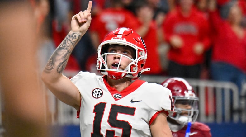 Georgia Bulldogs quarterback Carson Beck (15) celebrates a touchdown against the Alabama Crimson Tide on a 1-yard run during the second half of the SEC Championship football game at the Mercedes-Benz Stadium in Atlanta, on Dec. 2, 2023. (Hyosub Shin / Hyosub.Shin@ajc.com)
