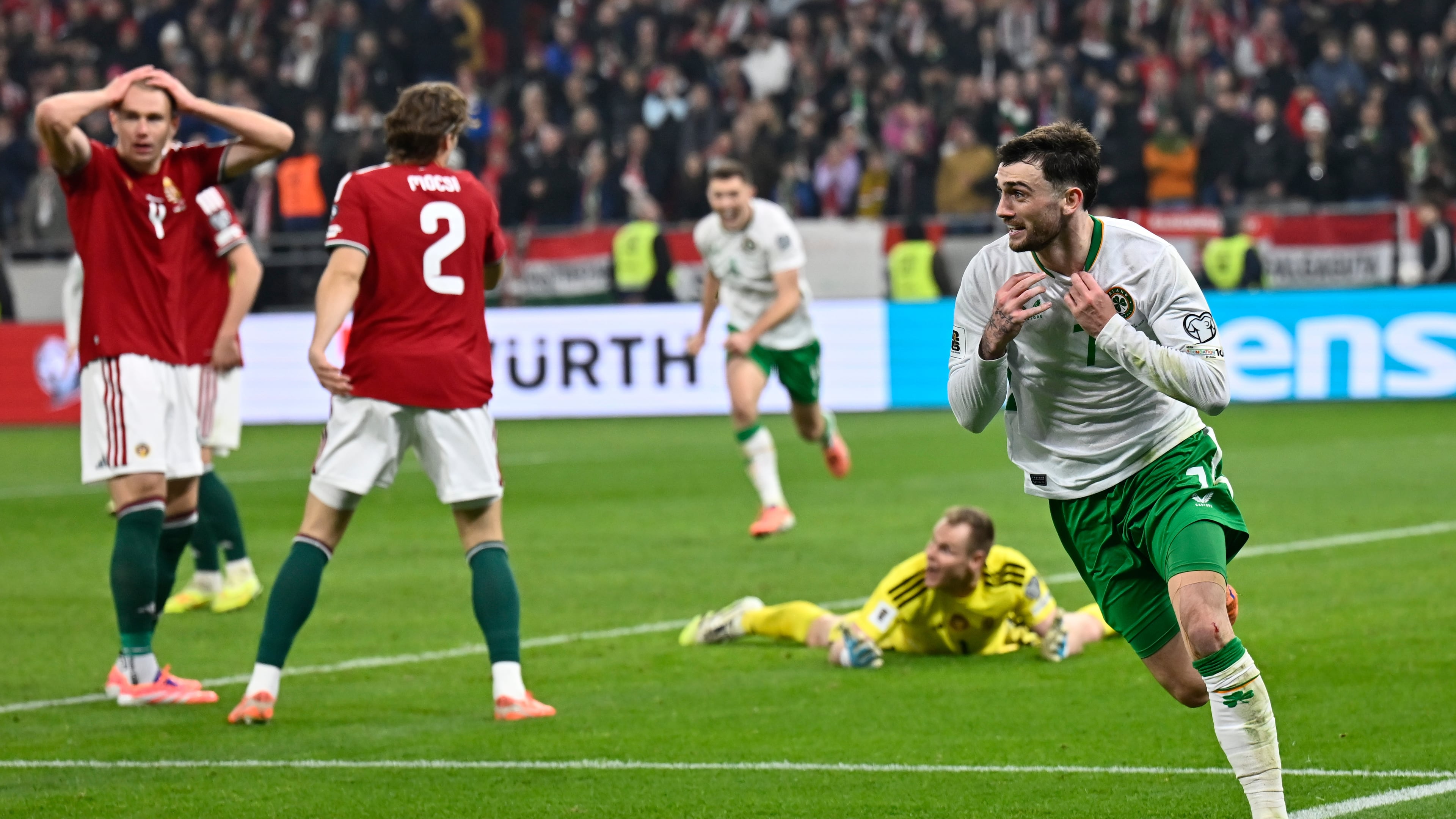 Ireland's Troy Parrott, right, celebrates after scoring his side's third goal during the World Cup 2026 group F qualifying soccer match between Hungary and Ireland in Budapest, Hungary, Sunday, Nov. 16, 2025. (AP Photo/Denes Erdos)