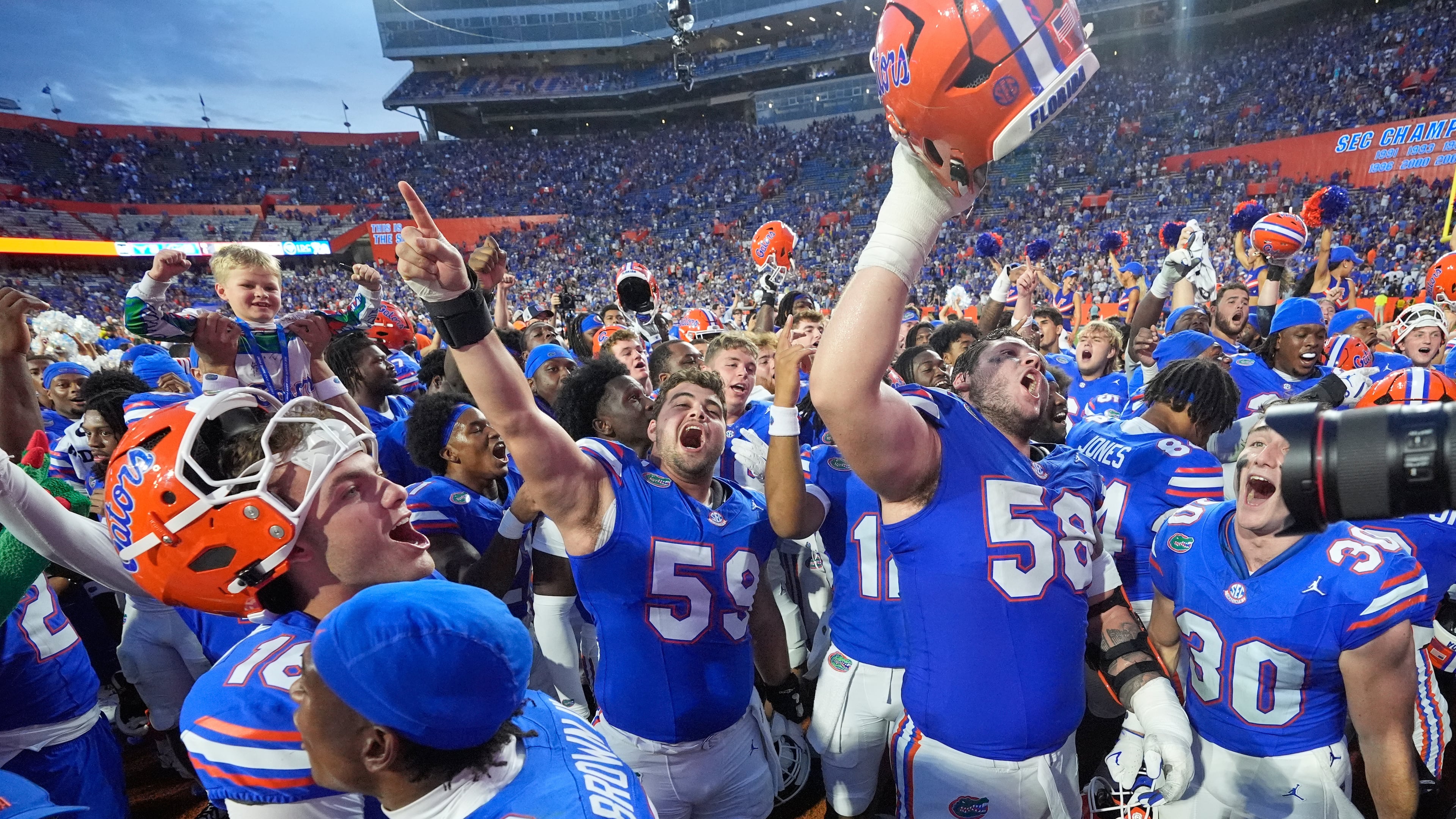 Florida players celebrate after defeating Texas in an NCAA college football game, Saturday, Oct. 4, 2025, in Gainesville, Fla. (AP Photo/John Raoux)