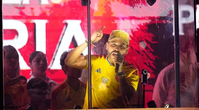Presidential candidate Abelardo de la Espriella of the Defenders of the Motherland movement addresses supporters from inside a bulletproof booth after leading the first round of the presidential election and advancing to a runoff in Barranquilla, Colombia, Sunday, May 31, 2026. (AP Photo/Fernando Vergara)