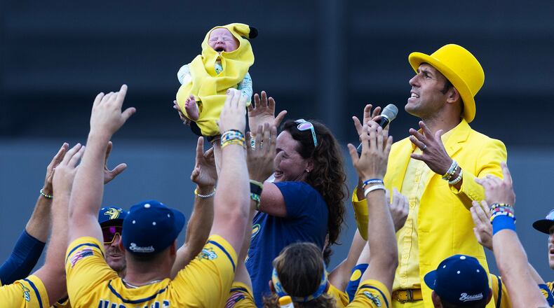 Savannah Bananas owner Jesse Cole and team members welcome a Banana Baby before a game against the Party Animals at Richmond County Bank Ball Park on Aug. 12, 2023, in New York. (Al Bello/Getty Images/TNS)