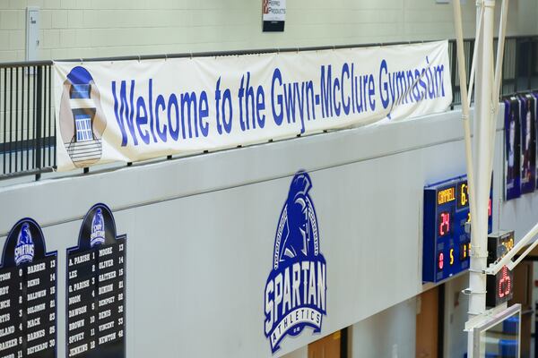 A sign welcoming fans to the Gwyn-McClure Gymnasium is shown during a Campbell girls’ basketball game against Osborne at Campbell High School, Tuesday, Jan. 13, 2026, in Smyrna, Ga. The Campbell girls and boys basketball coaches, Randy McClure and James Gwyn, were shockingly let go in March 2025, leading to a massive community outcry and a petition. They were later re-instated in April an now lead their teams during the 2025-26 season. The gymnasium is named after the long-time coaches. (Jason Getz/AJC)