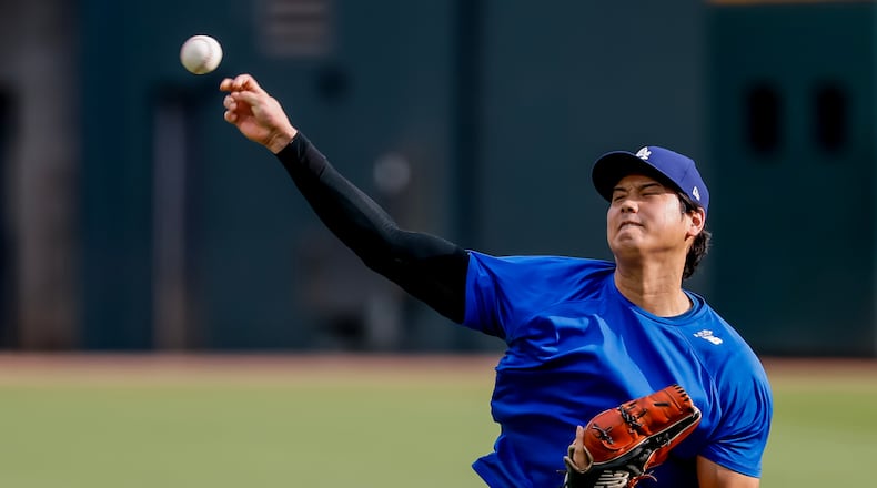 Los Angeles Dodgers pitcher Shohei Ohtani throws a practice session in the outfield before a baseball game against the Atlanta Braves, Thursday, Aug. 27, 2026, in Atlanta. (AP Photo/Erik S. Lesser)