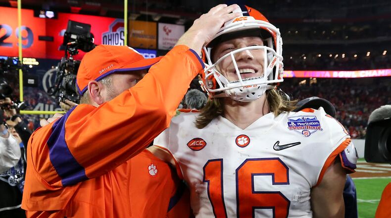 Clemson quarterback Trevor Lawrence (16) is congratulated after Clemson defeated Ohio State 29-23 in the Fiesta Bowl NCAA college football playoff semifinal Saturday, Dec. 28, 2019, in Glendale, Ariz. (AP Photo/Ross D. Franklin)