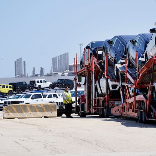 FILE - A transport carrying new cars arrives at a Stellantis facility July 10, 2023, in Belvidere. Ill. (AP Photo/Charles Rex Arbogast, File)