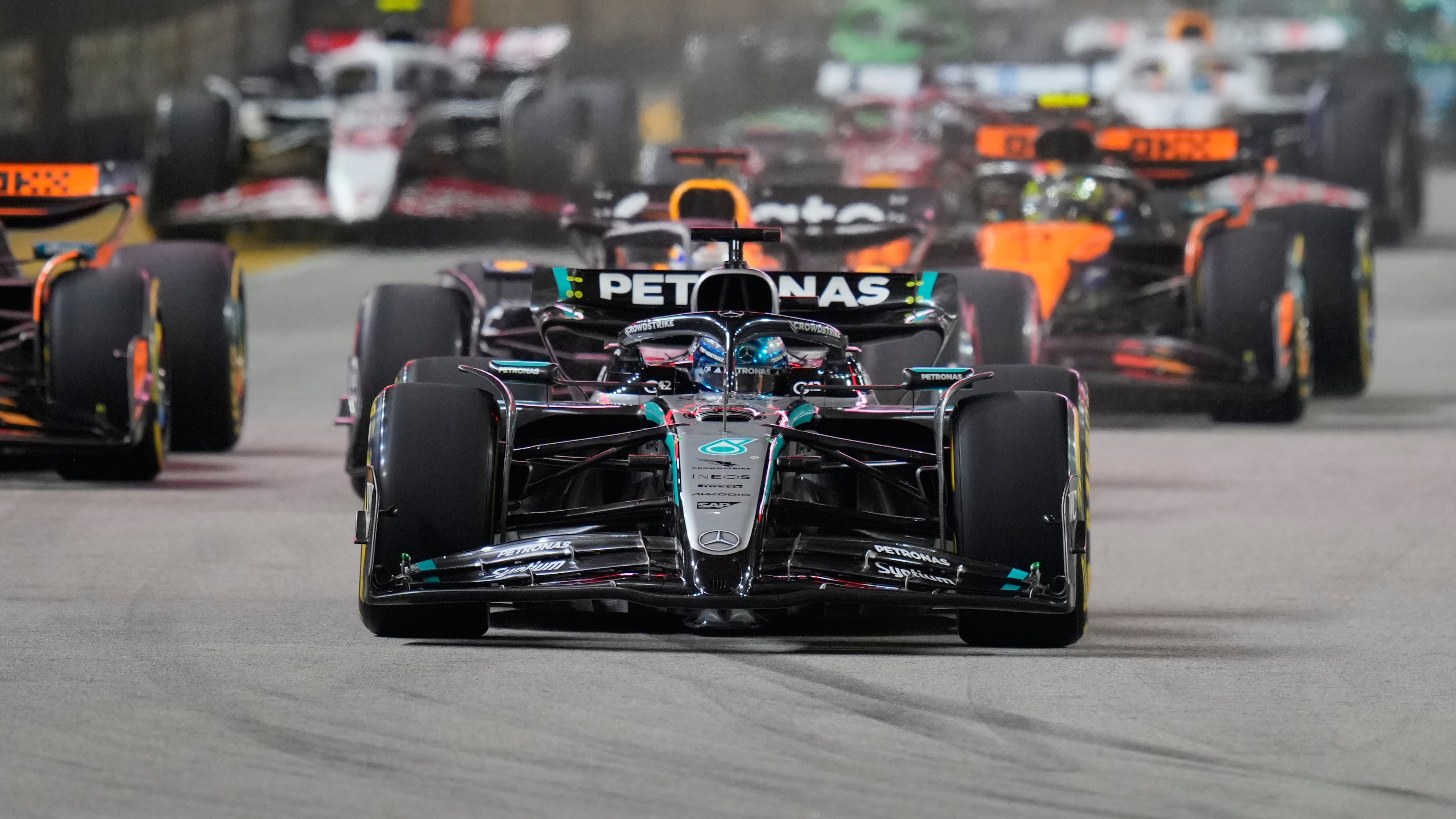 Mercedes driver George Russell of Britain leads the field after the start during the Singapore Formula One Grand Prix at the Marina Bay Street Circuit in Singapore, Sunday, Oct. 5, 2025. (AP Photo/Vincent Thian)