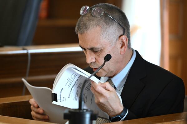 Dr. Garrey Faller reviews the medical record of defendant Karen Read as he testified during her trial, Friday, April 25, 2025, at Norfolk Superior Court in Dedham, Mass. (Josh Reynolds/New York Post via AP, Pool)
