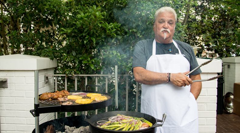 Braai Master Derek Anthony grilling Sosatie and Grilled Pineapple and Red Onion Salad on the Kudu grill. Photo credit- Mia Yakel.