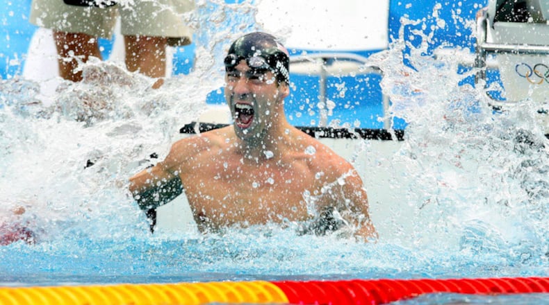 Michael Phelps celebrates his 7th gold medal at the 2008 Summer Olympics after winning the men's 100 meter butterfly in Beijing, Aug. 16, 2008. Covering 3,300 meters in 17 races over nine days, Phelps won eight gold medals and set seven world records. All without taking a day off. (Doug Mills/The New York Times)