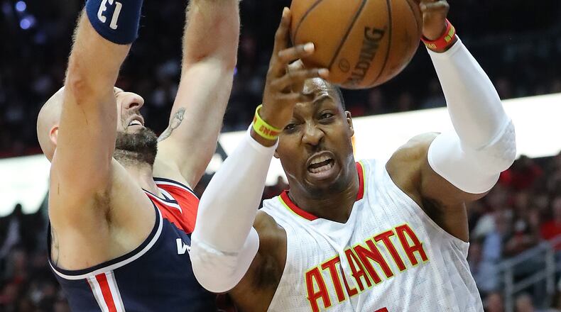 Atlanta Hawks center Dwight Howard battles Washington Wizards' Marcin Gortat for a rebound in game 4 of their first-round playoff series Monday, April 24, 2017, in Atlanta.