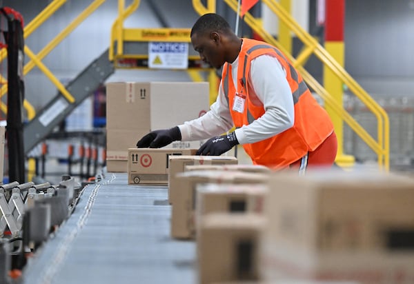 Workers sort packages at the Target facility in Lawrenceville on Friday, Nov. 21, 2025. The facility handled about 3.5 million packages in 2024. (Hyosub Shin/AJC)