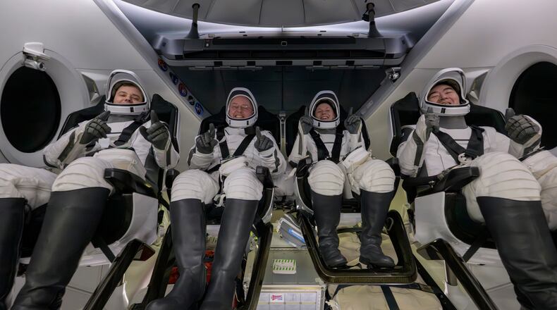 Roscosmos cosmonaut Oleg Platonov, left, NASA astronauts Mike Fincke, Zena Cardman, and JAXA (Japan Aerospace Exploration Agency) astronaut Kimiya Yui are seen inside the SpaceX Dragon Endeavour spacecraft onboard the SpaceX recovery ship SHANNON shortly after having landed in the Pacific Ocean off the coast of Long Beach, Calif., Thursday, Jan. 15, 2026. (NASA via AP)