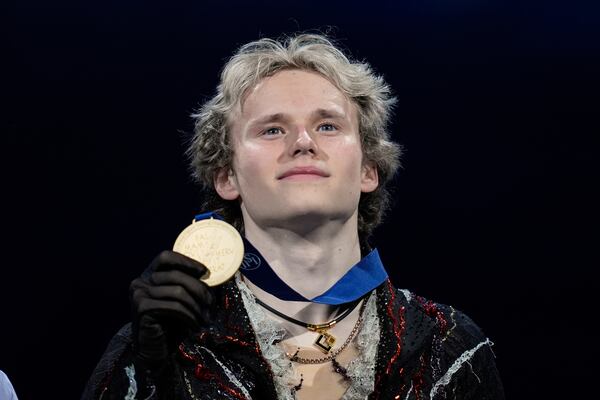 Gold medalist Ilia Malinin, of the United States, holds his medal during a medal ceremony for men's free skating at the figure skating world championships, Saturday, March 29, 2025, in Boston. (AP Photo/Charles Krupa)