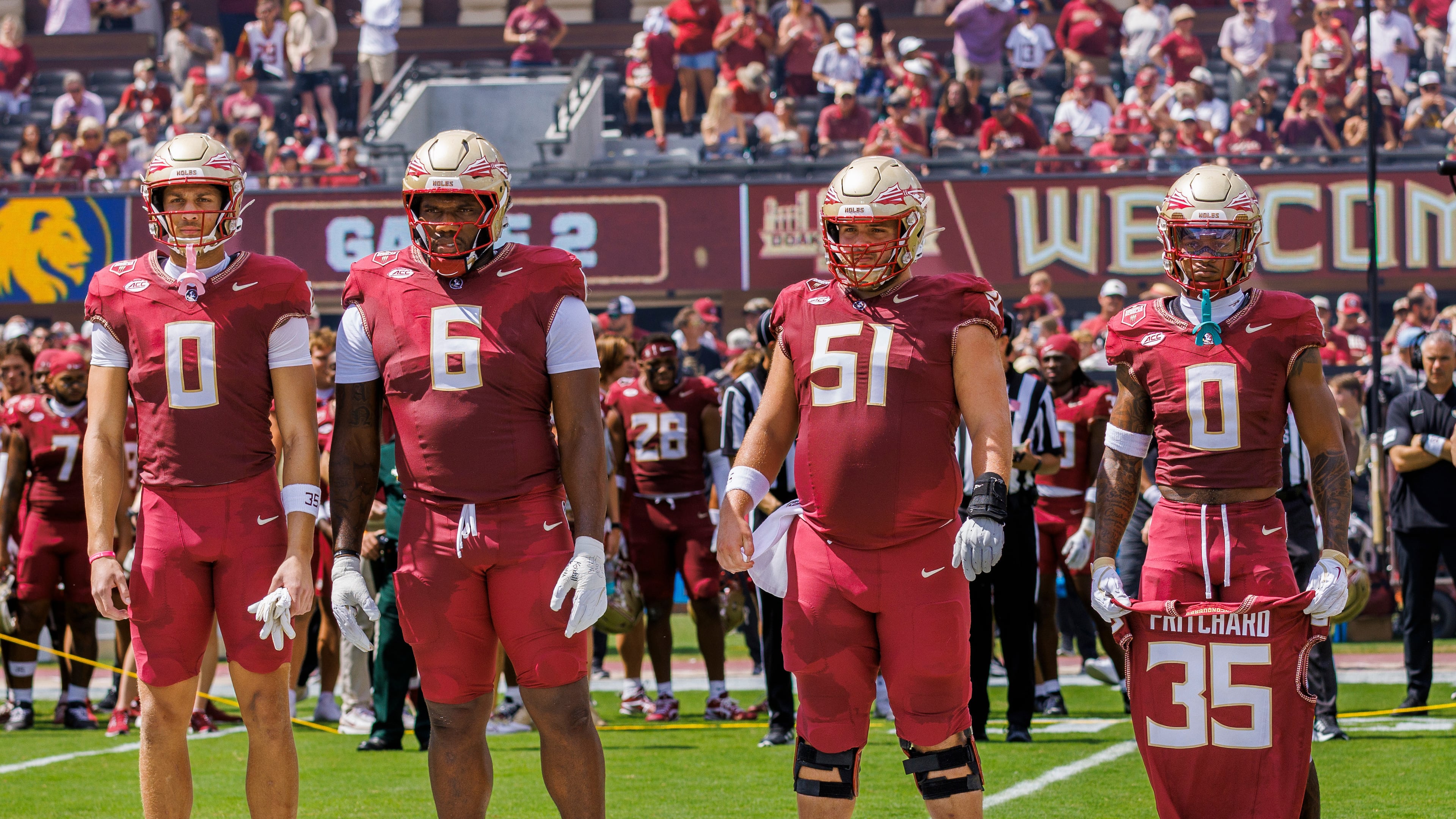 FILE - Florida State defensive back Earl Little Jr. (0) right, holds the jersey of linebacker Ethan Pritchard (35), as he is joined by Duce Robinson (0), Darrell Jackson Jr. (6), and Luke Petitbon (51) before the start of an NCAA college football game against East Texas A&M, Sept. 6, 2025, in Tallahassee, Fla. (AP Photo/Colin Hackley, File)