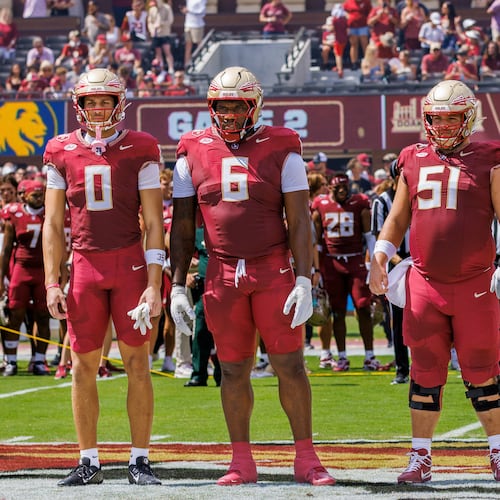 FILE - Florida State defensive back Earl Little Jr. (0) right, holds the jersey of linebacker Ethan Pritchard (35), as he is joined by Duce Robinson (0), Darrell Jackson Jr. (6), and Luke Petitbon (51) before the start of an NCAA college football game against East Texas A&M, Sept. 6, 2025, in Tallahassee, Fla. (AP Photo/Colin Hackley, File)