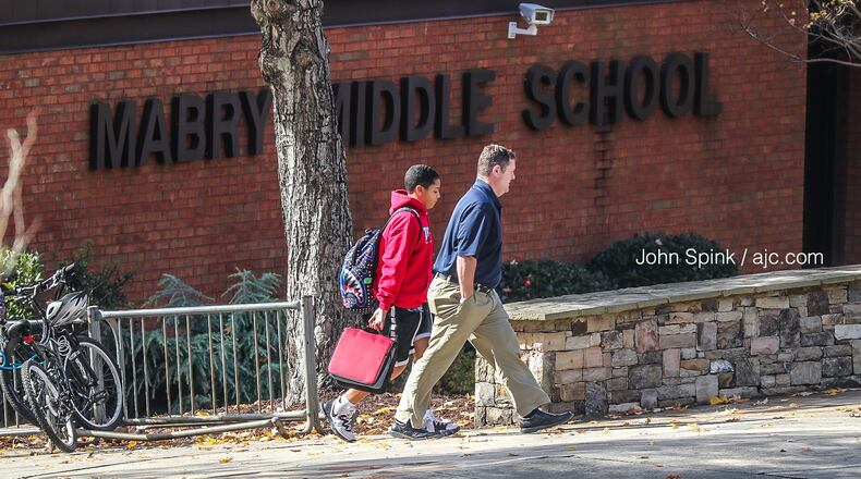 A student leaves with an adult from Mabry Middle School on Monday, Nov. 11, 2019 while it was business as usual after school district officials confirmed Monday that a Cobb County middle schooler has been diagnosed with measles (the student in the photo is not the infected student).