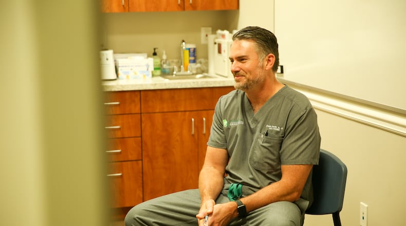 Dr. Charles Procter meets with a patient on "Too Large" on Discovery+. TLC