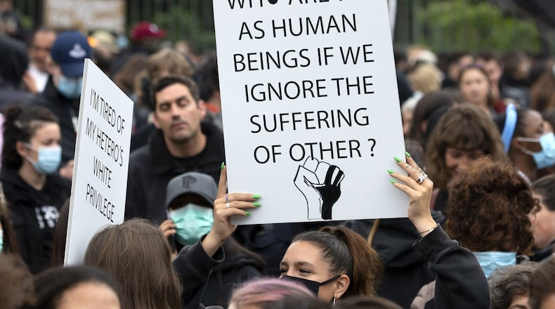 Several thousand demonstrators take part in an anti-racism demonstration, against police violence and in memory of George Floyd, during a Black Lives Matter (BLM) protest, in Geneva, Switzerland, Tuesday, June 9, 2020. (Salvatore Di Nolfi/Keystone via AP)