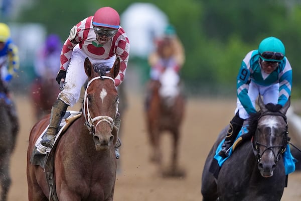 Umberto Rispoli, left, atop Journalism, reacts after edging out Luis Saez, atop Gosger, to win the the 150th running of the Preakness Stakes horse race Saturday, May 17, 2025, at Pimlico Race Course in Baltimore. (AP Photo/Nick Wass)