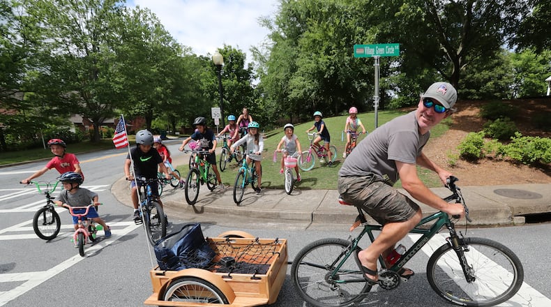 051920 Smyrna: Jerry Luzar leads a daily Smyrna PE class for children whose parents are tied of them sitting at home starting out on their daily 5 to 7 mile bike ride from the Smyrna Community Center on Tuesday, May 19, 2020, in Smyrna. Curtis Compton ccompton@ajc.com