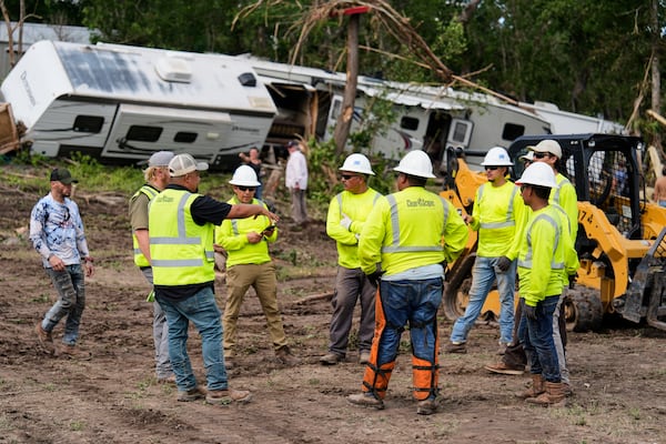 People help during clean-up efforts at Guadalupe Keys Resort, an RV park in Center Point, Texas, after flooding, Monday, July 7, 2025. (AP Photo/Ashley Landis)