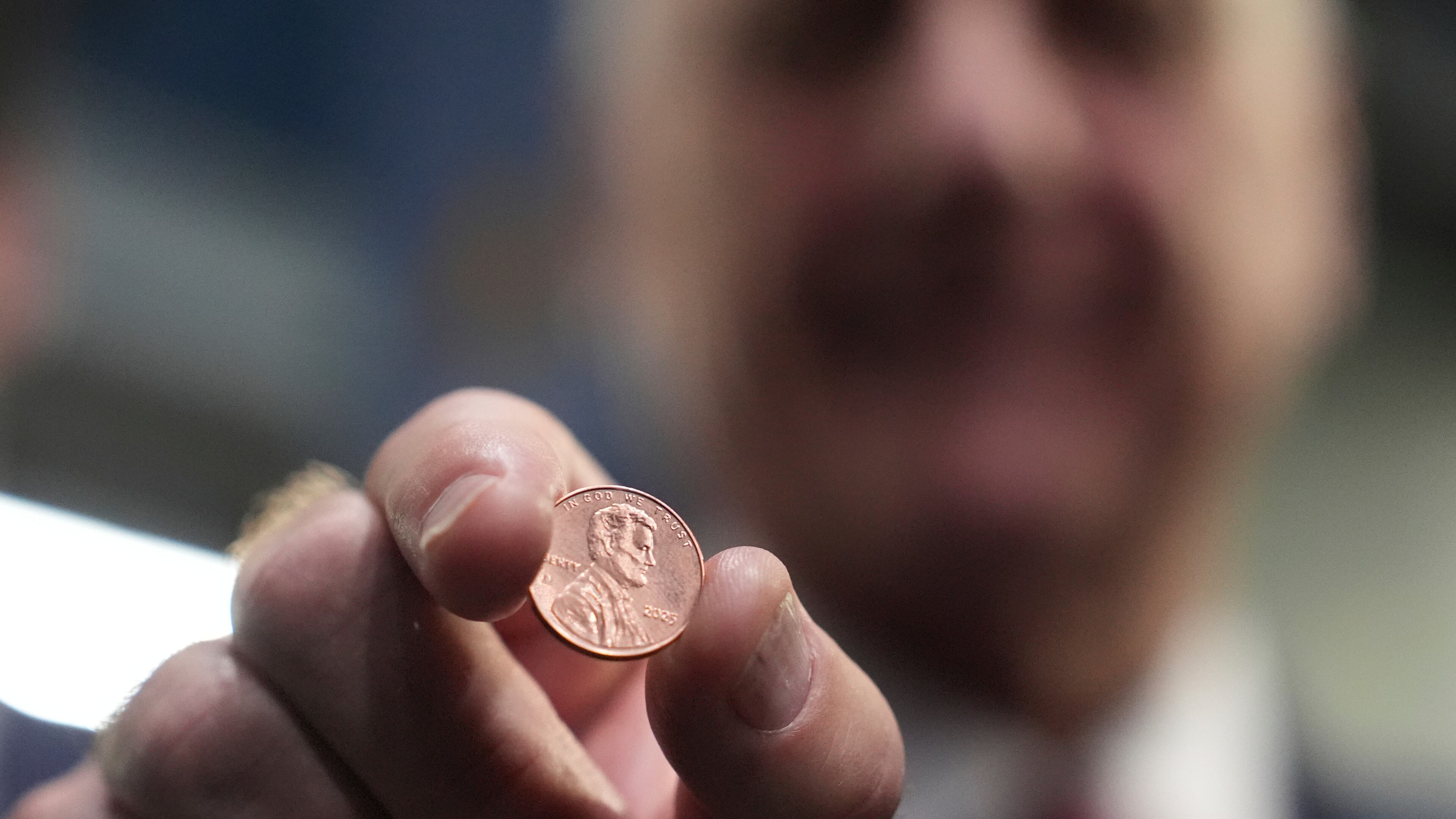U.S. Treasurer Brandon Beach holds one of the last pennies pressed at the U.S. Mint in Philadelphia, Wednesday, Nov. 12, 2025. (AP Photo/Matt Slocum)