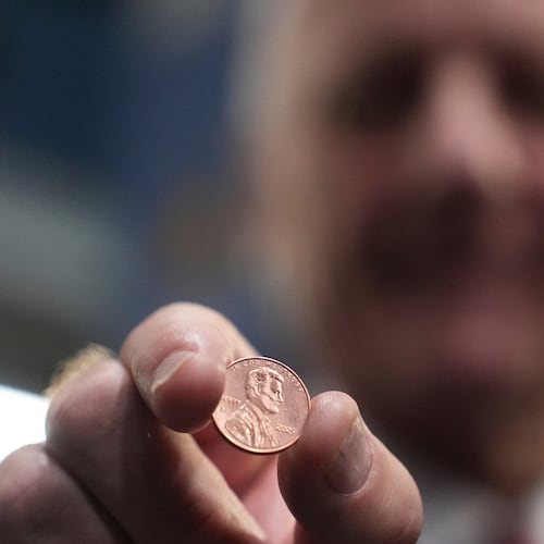 U.S. Treasurer Brandon Beach holds one of the last pennies pressed at the U.S. Mint in Philadelphia, Wednesday, Nov. 12, 2025. (AP Photo/Matt Slocum)