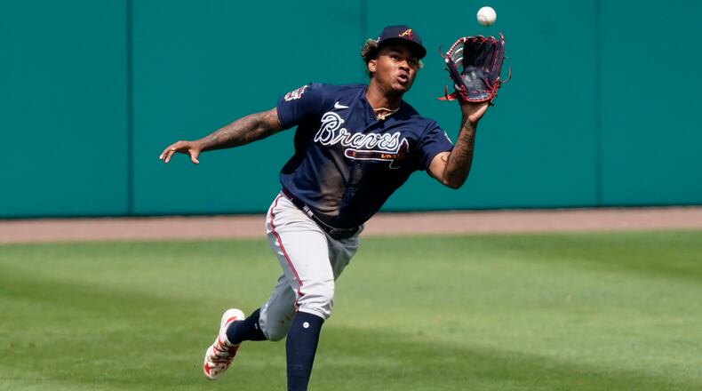 Braves center fielder Cristian Pache makes a running catch on a fly ball by Minnesota Twins' Josh Donaldson in the fifth inning of a spring training baseball game against the Atlanta Braves Monday, March 22, 2021, in Fort Myers, Fla.