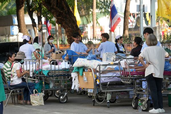 Hospital patients lay on beds outdoors after a 7.7 magnitude earthquake in Bangkok, Thailand, Friday, March 28, 2025. (AP Photo/Sakchai Lalit)