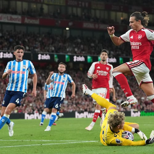 Arsenal's Riccardo Calafiori leaps over Coventry City's goalkeeper Carl Rushworth during the English Premier League soccer match between Arsenal and Coventry City in London, Friday, Aug. 21, 2026. (AP Photo/Kirsty Wigglesworth)