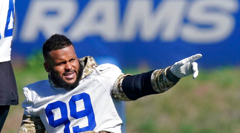 Los Angeles Rams defensive end Aaron Donald gesture prior to practice for an NFL Super Bowl football game Wednesday, Feb. 9, 2022, in Thousand Oaks, Calif. The Rams are scheduled to play the Cincinnati Bengals in the Super Bowl on Sunday. (AP Photo/Mark J. Terrill)