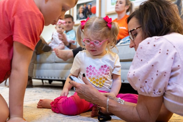 Hope Filchak, 4, plays with her brother, Thomas, 7, and caregiver Kristen Maxwell at the Filchak home near Gainesville. Hope, who has MLS syndrome, relies on the drug elamipretide, which is up for FDA approval. (Arvin Temkar/AJC)