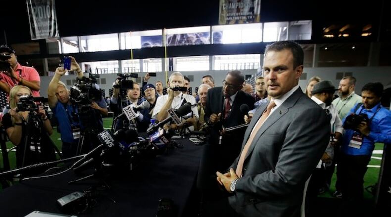 Texas head football coach Tom Herman takes a seat before speaking to reporters during the Big 12 NCAA college football media day in Frisco, Texas, Tuesday, July 18, 2017. (AP Photo/LM Otero)