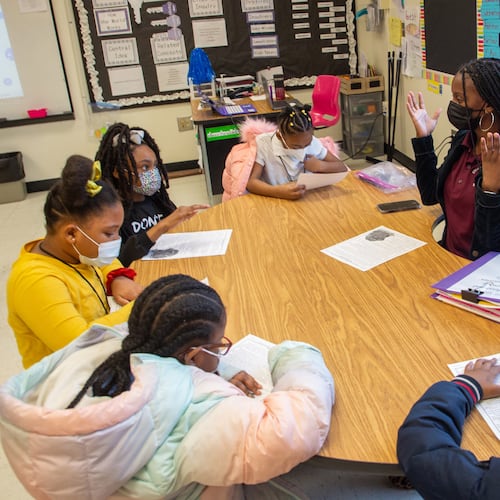 In this file photo, Stonewall Tell Elementary School teacher Sadeka Gillard works with her students on their reading assignment. (Steve Schaefer for The Atlanta Journal-Constitution)