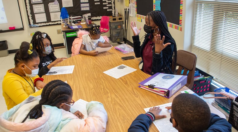 Stonewall Tell Elementary School third grade teacher Sadeka Gillard works with her students on their reading assignment Tuesday, Jan. 25, 2022. The school did not report substantial absences in January, but it has numerous strategies to help students who do miss class. STEVE SCHAEFER FOR THE ATLANTA JOURNAL-CONSTITUTION