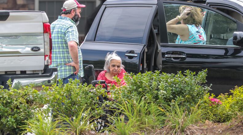 July 16, 2021: Acworth: The last resident to leave the facility is helped into a vehicle as all residents were to have been moved out of Tranquil Gardens Assisted Living and Memory Care in Acworth by Noon on Friday, July 16, 2021 after owners informed residents and workers they were foreclosed. Tranquil Gardens Assisted Living and Memory Care informed their residents on Tuesday that the property was being foreclosed on and they would need to move out by Friday. (John Spink / John.Spink@ajc.com)