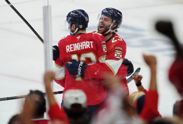 Florida Panthers' Sam Reinhart (13) celebrates his goal against the Edmonton Oilers with Carter Verhaeghe (23) during the second period in Game 3 of the NHL hockey Stanley Cup finals in Sunrise, Fla., Monday, June 9, 2025. (Nathan Denette/The Canadian Press via AP)