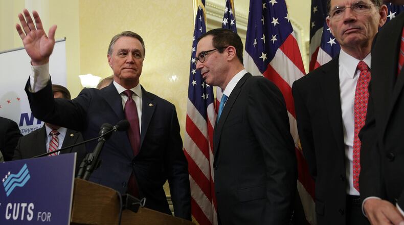U.S. Sen. David Perdue (R-GA), left, with Secretary of the Treasury Steven Mnuchin and Sen. John Barrasso (R-WY) earlier this week on Capitol Hill. (Photo by Alex Wong/Getty Images)