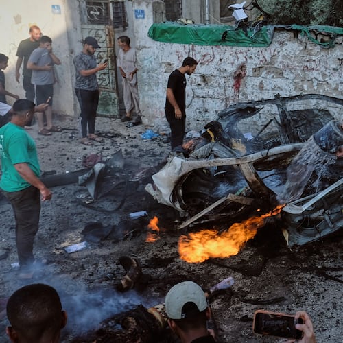 EDS NOTE: GRAPHIC CONTENT - Palestinians try to extinguish a burning car after an Israeli military strike in Gaza City, Sunday, Aug. 2, 2026. (AP Photo/Jehad Alshrafi)