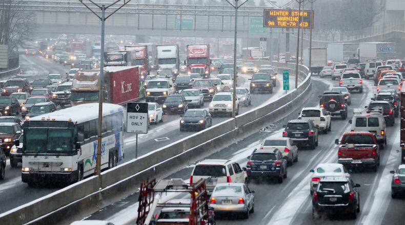 Were you stuck in this or stranded in the office? On Tuesday, Jan. 28, 2014, Snowmageddon day, Atlanta traffic was gridlocked on the Downtown Connector and I-285 on as many employers sent workers home early --  all at the same time. People were stuck in traffic for hours or else stranded at work or school. We were reminded of that day this week when schools were closed or delayed in opening due to predicted winter weather. JOHN SPINK/JSPINK@AJC.COM