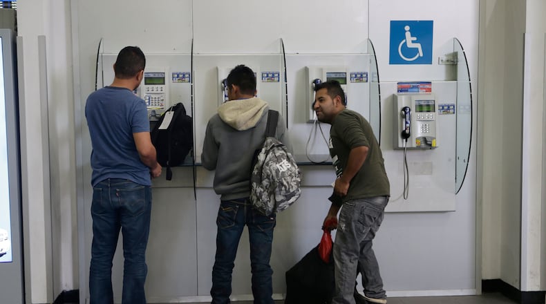 Mexican citizens use pay phones at the airport after being deported from the U.S., in Mexico City, Thursday, Feb. 23, 2017. While U.S. Homeland Security Secretary John Kelly and U.S. Secretary of State Rex Tillerson tried to alleviate Mexico's concerns during a visit to Mexico City, President Donald Trump was fanning them further with tough talk about "getting really bad dudes out of this country at a rate nobody has ever seen before." (AP Photo/Marco Ugarte)