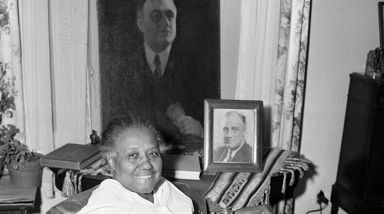 Elizabeth "Lizzie" McDuffie, who was a maid to Franklin Delano Roosevelt when he was president, is shown inside her Atlanta home with some of the souvenirs he gave her. (AP/Shutterstock)