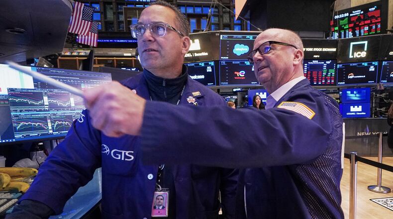 Specialist Anthony Matesic, left, and trader Patrick Casey work on the floor of the New York Stock Exchange, Tuesday, Nov. 18, 2025. (AP Photo/Richard Drew)