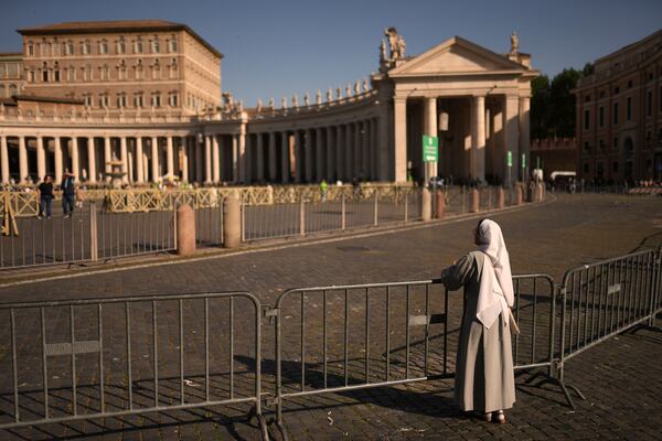 A nun leans on railings in St. Peter's Square at the Vatican,Tuesday, April 22, 2025. (AP Photo/Francisco Seco)